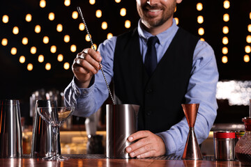 Bartender preparing fresh alcoholic cocktail in bar, closeup
