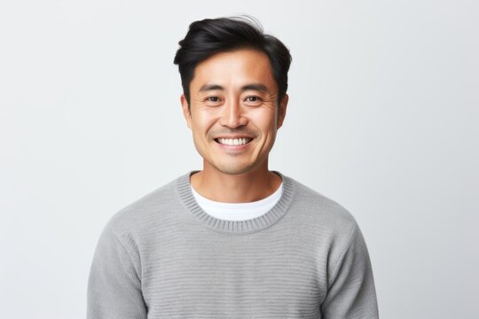 Medium Shot Portrait Photography Of A Happy Vietnamese Man In His 30s Wearing A Cozy Sweater Against A White Background