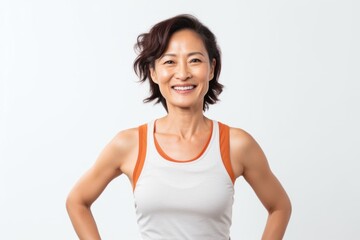 Fototapeta na wymiar Medium shot portrait photography of a Vietnamese woman in her 40s wearing a sporty tank top against a white background