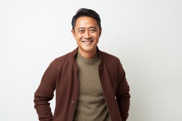 Lifestyle portrait photography of a Vietnamese man in his 40s against a white background