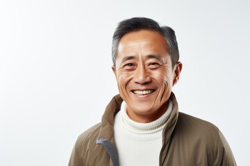 Lifestyle portrait photography of a happy Vietnamese man in his 50s against a white background