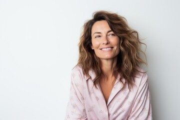 Obraz premium Medium shot portrait photography of a French woman in her 40s wearing a snuggly pajama set against a white background