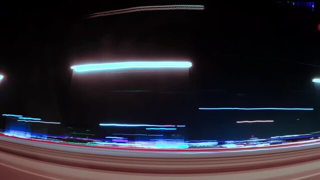 Motion timelapse of a night drive in a city . Side view from the car 