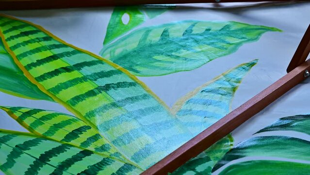 Drawing leaves by hand is one step in making a Lanna umbrella, Chiang Mai province.