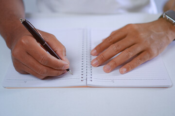 Author Hand Holding Pen Write in Notebook, Writing Journal Concept
