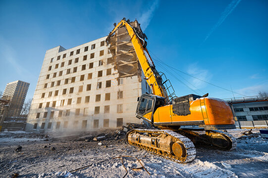 Demolition of residential building with crawler excavator
