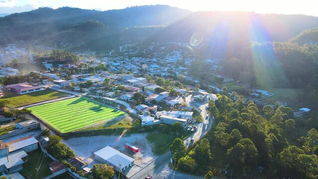 Idyllic view over a small town named Marcala City in Honduras and with sunset sunrays coming from top of a hill