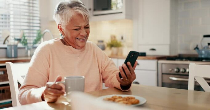 Happy senior woman, phone and coffee with funny video, social media post or streaming comedy in her home kitchen. Elderly person laughing on mobile chat, internet meme and drinking tea and cookies