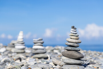 Pebble tower balance harmony stones arrangement on sea beach coastline