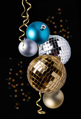 golden and silver christmas balls, bokeh and serpentine on a dark background, christmas decor