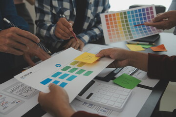 Close up ux developer and ui designer brainstorming about mobile app interface wireframe design on...