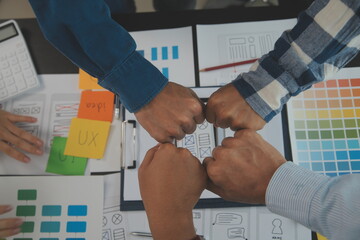 Close up ux developer and ui designer brainstorming about mobile app interface wireframe design on...