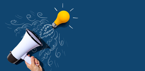 Attention and announcement concept with an idea light bulb flying to the sky like a rocket - Flat lay