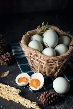 salted eggs, duck eggs in the bamboo basket and sackcloth with dark background. split salted eggs.