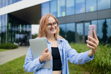 Happy business woman holding a digital tablet reading a text message on her phone while commuting to work in the city. High quality photo