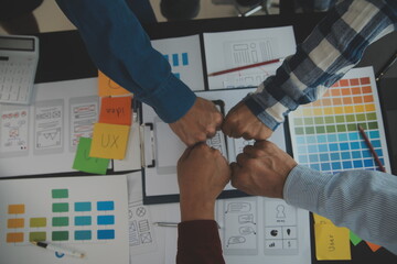 Close up ux developer and ui designer brainstorming about mobile app interface wireframe design on...