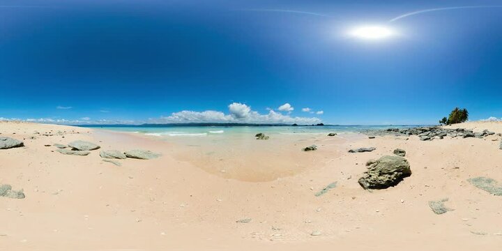 Ocean waves over the white sand beach in Hagonoy Island. Britania Island. Surigao de Sur, Philippines. VR 360.