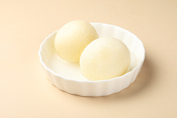 This dessert is called Rasgulla or Rosogolla, they are served in a bowl 
