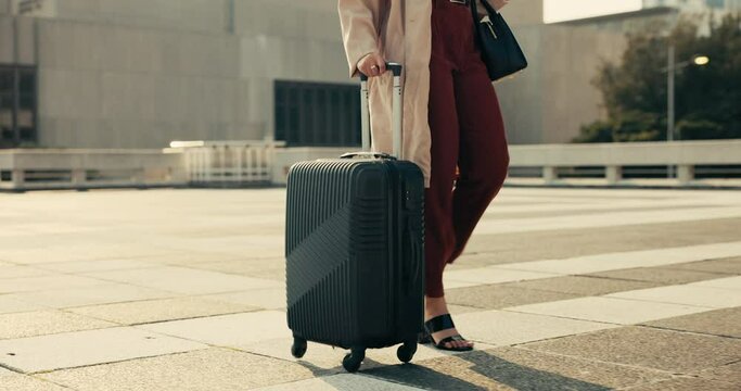 Feet, woman and walking with luggage for business outdoor on ground of rooftop, building or city for trip. Professional, person and legs with suitcase and steps to commute for career journey or work