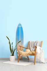 Interior of living room with surfboard and plaid on armchair