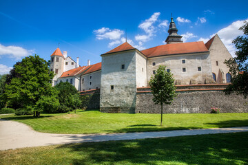 The Castle of Telc in the Czech Republic, with the Tower of the Church of St James - obrazy, fototapety, plakaty