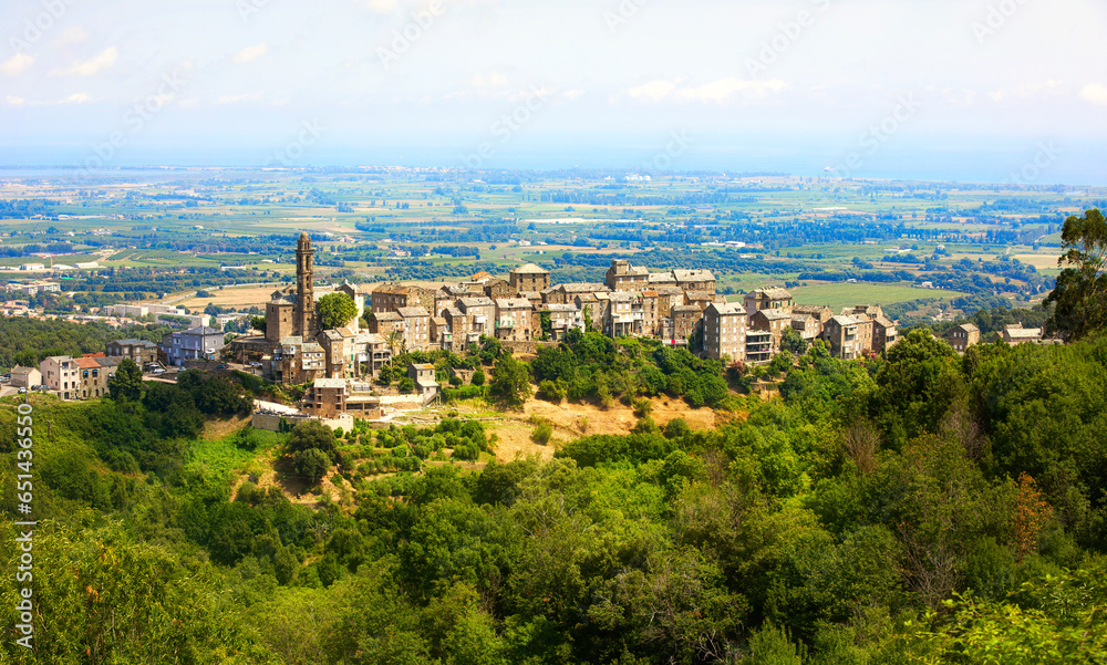 Wall mural view of the beautiful city of venzolasca on corsica, with the santa lucia church