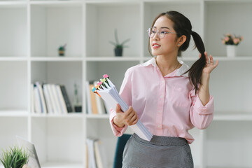 Portrait of beautiful asian secretary woman smiling while working in office.