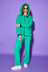 Fashion asian female model in green down jacket and pants. - 651440353