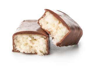 Halves of tasty chocolate covered coconut candy on white background