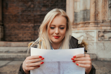 Map-holding woman anticipates smartphone's navigational takeover