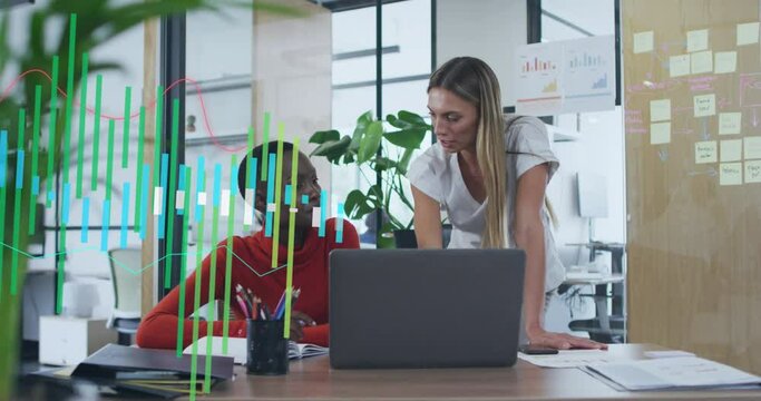 Animation of graphs over diverse female coworkers discussing reports on desktop in office
