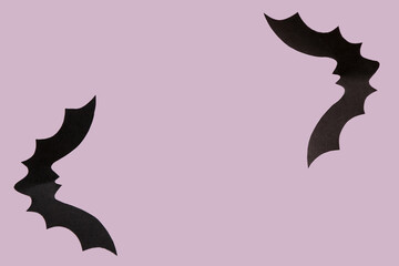 Paper bats for Halloween party on lilac background