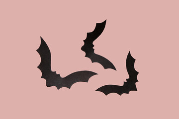 Paper bats for Halloween party on pink background