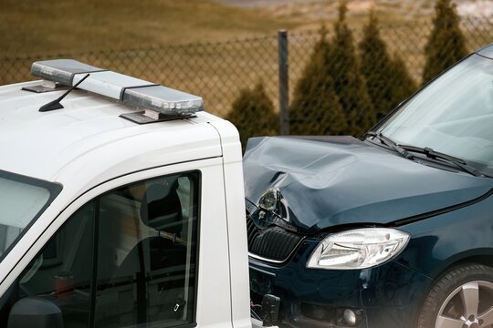 Close-Up of Vehicle Front Damage After City Street Collision. Car with a  damaged hood after the road accident. Vehicle front crash close-up.