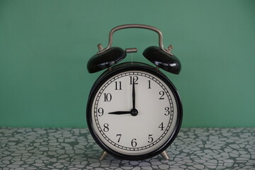 alarm clock on green - 651463316
