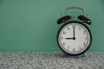 alarm clock on green background - 651463357