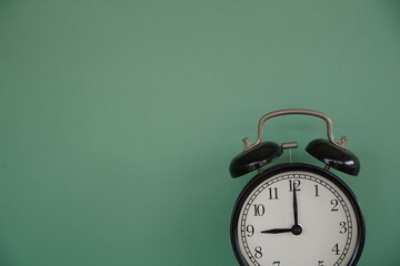 alarm clock on green background - 651463362