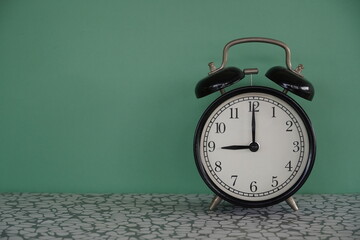 alarm clock on green background