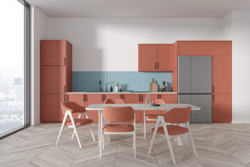Cozy home kitchen interior with cooking and eating area, panoramic window