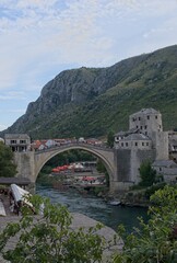 Fototapeta na wymiar Mostar, Bosnia and Herzegovina - Sep 15, 2023: Old bridge. A walking in the center of Mostar city in Bosnia and Herzegovina federation in a sunny summer afternoon. Selective focus.