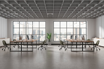 White open space office with green chairs
