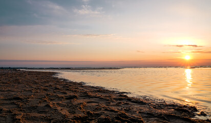 Sunset on the Baltic Sea in Poland. Landscape in the evening with setting sun by the sea.