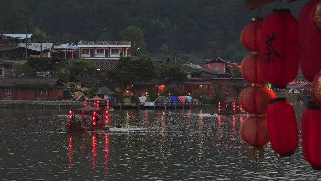 Asian chinese boat with red lanterns on a lake. Thailand