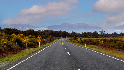 Fototapeta premium The Road trip view of travel scene and foggy in the morning scene at fiordland national park