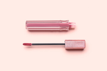 Stylish lipstick with brush on pink background