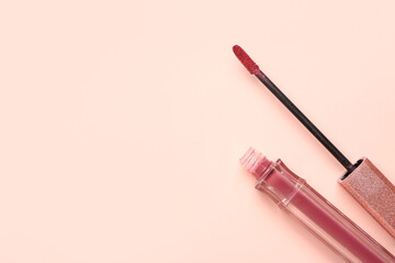 Stylish lipstick with brush on pink background