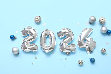 Figure 2024 made of balloons with Christmas balls on blue background