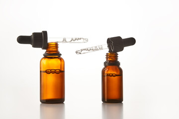 Two amber dropper vials with aromatherapy essence.