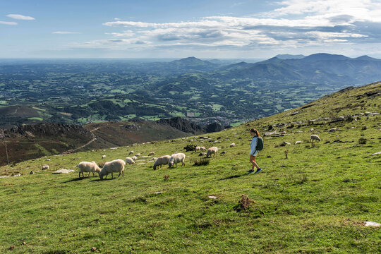 Beautiful young girl and her backpack hiking on "La-Ruhne" in the Fench Baque country