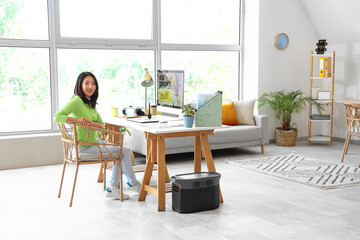 Asian interior designer working at table in office